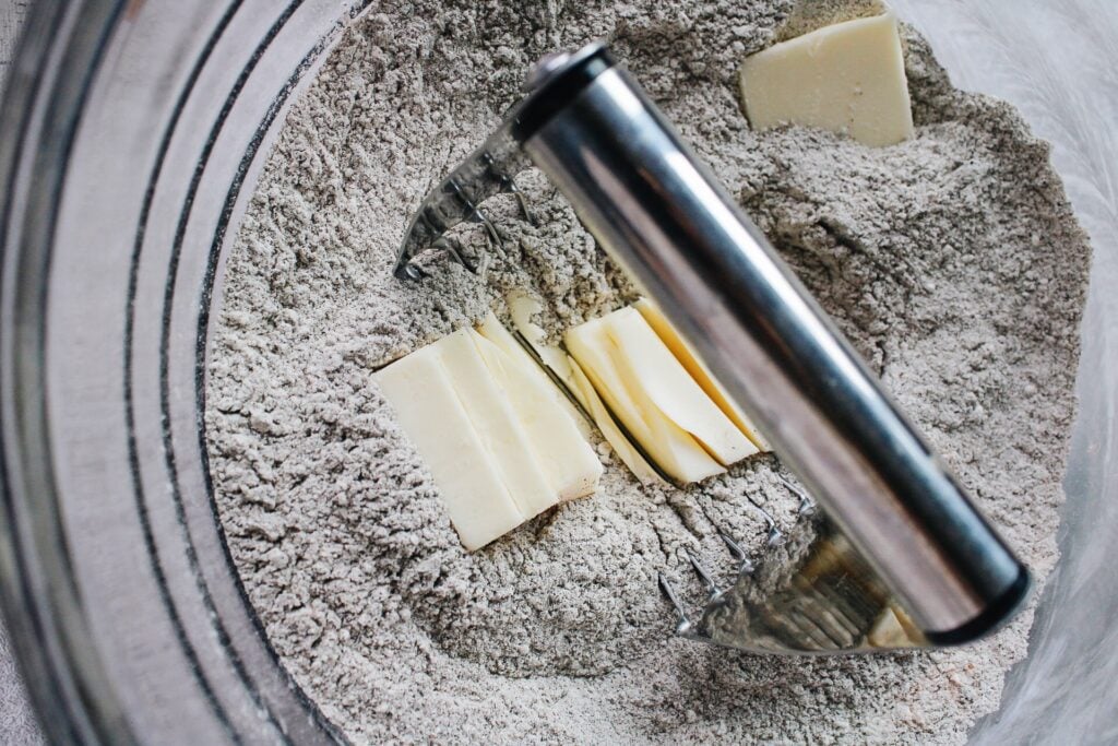 a pastry blender cutting butter into scone dry ingredients