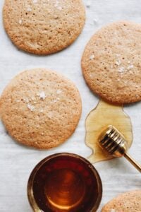honey cookies on parchment paper sprinkled with sea salt