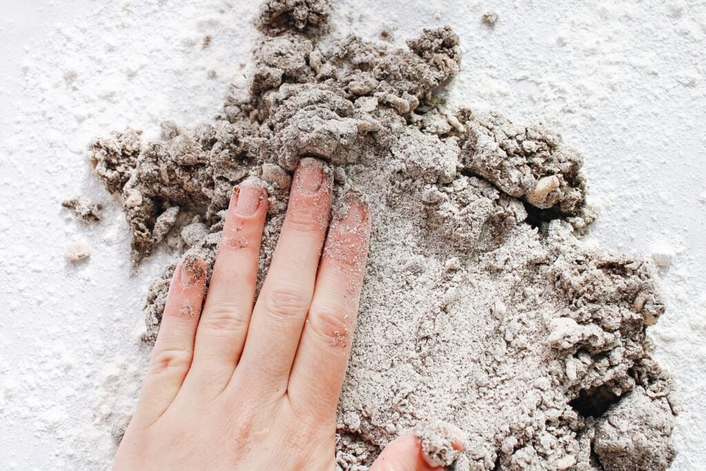 hand pressing dry scone flour into dough