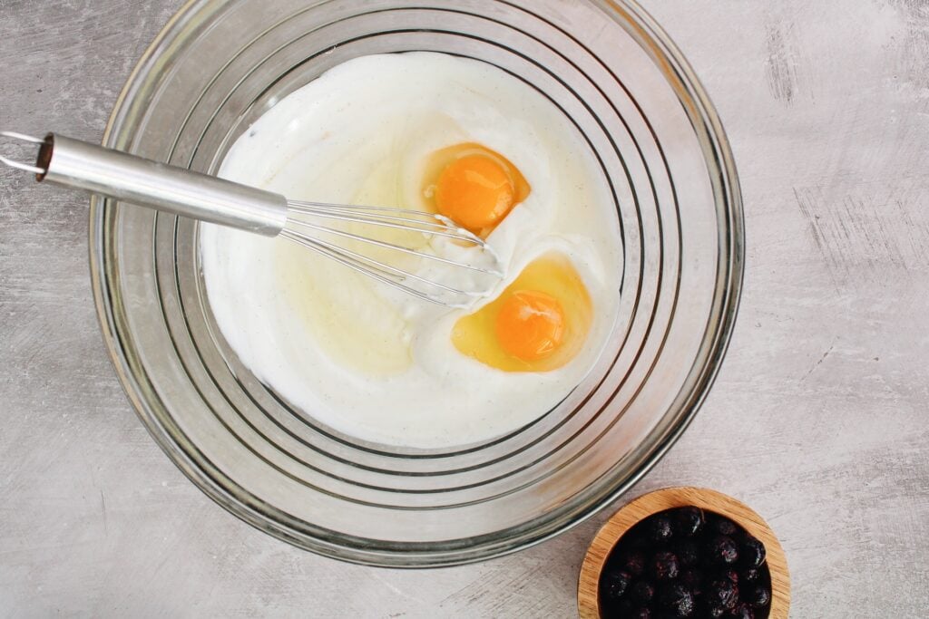 wet ingredients for buckwheat blueberry muffins in a mixing bowl