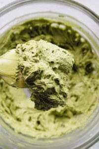 smooth and creamy matcha frosting on a rubber spatula