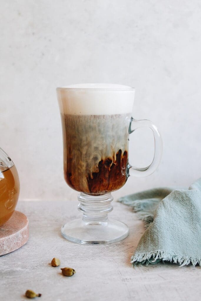 cardamom coffee latte in a clear glass mug