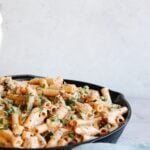 creamy chipotle chicken pasta in a cast iron skillet