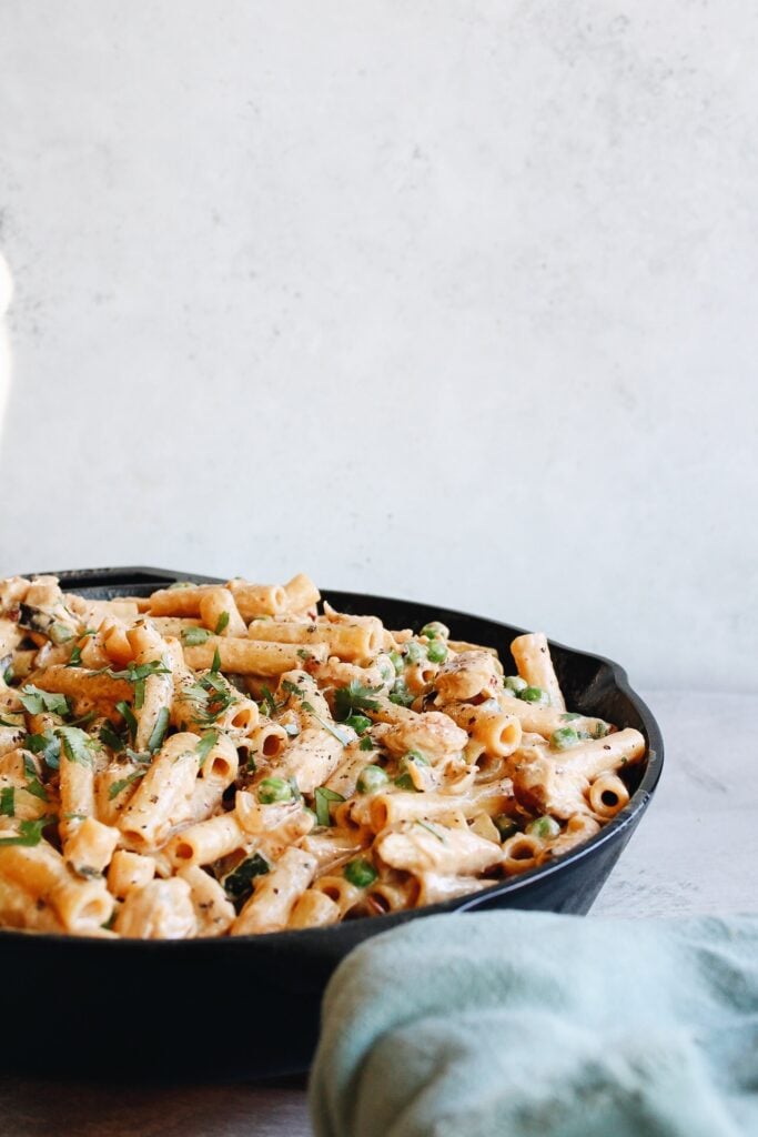 creamy chipotle chicken pasta in a cast iron skillet