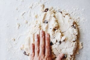 date scones being kneaded on a floured surface