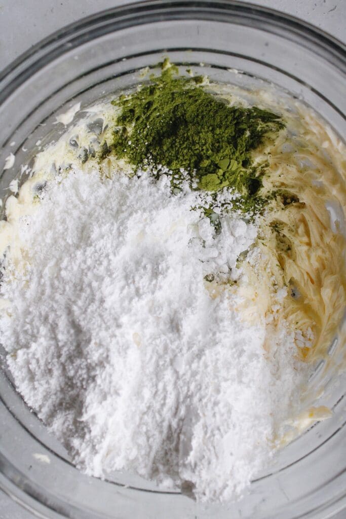 powdered sugar, matcha green tea powder and milk added to whipped butter