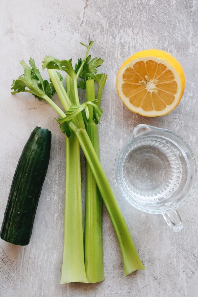celery cucumber juice ingredients on a gray background