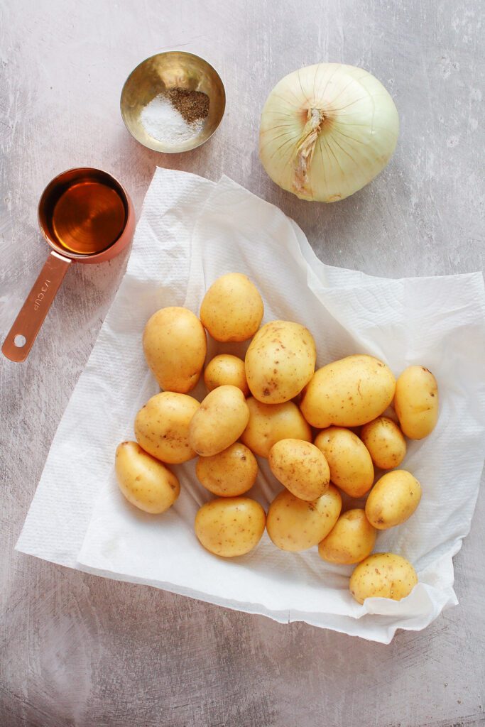 ingredients for skillet fried breakfast potatoes on a gray background