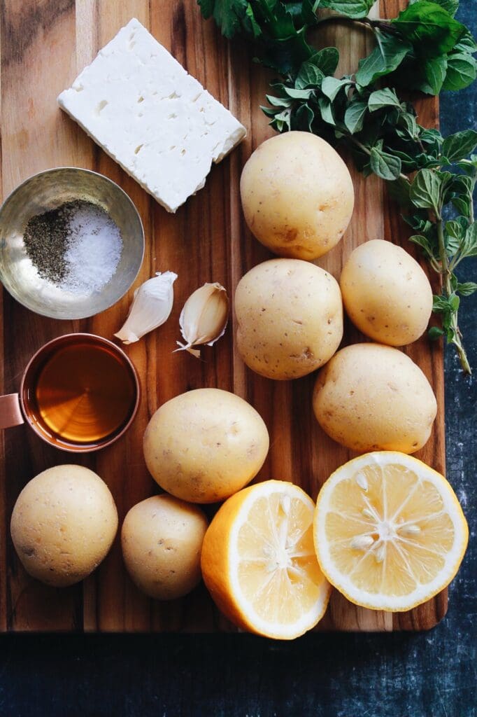 mediterranean potato ingredients on a wooden cutting board