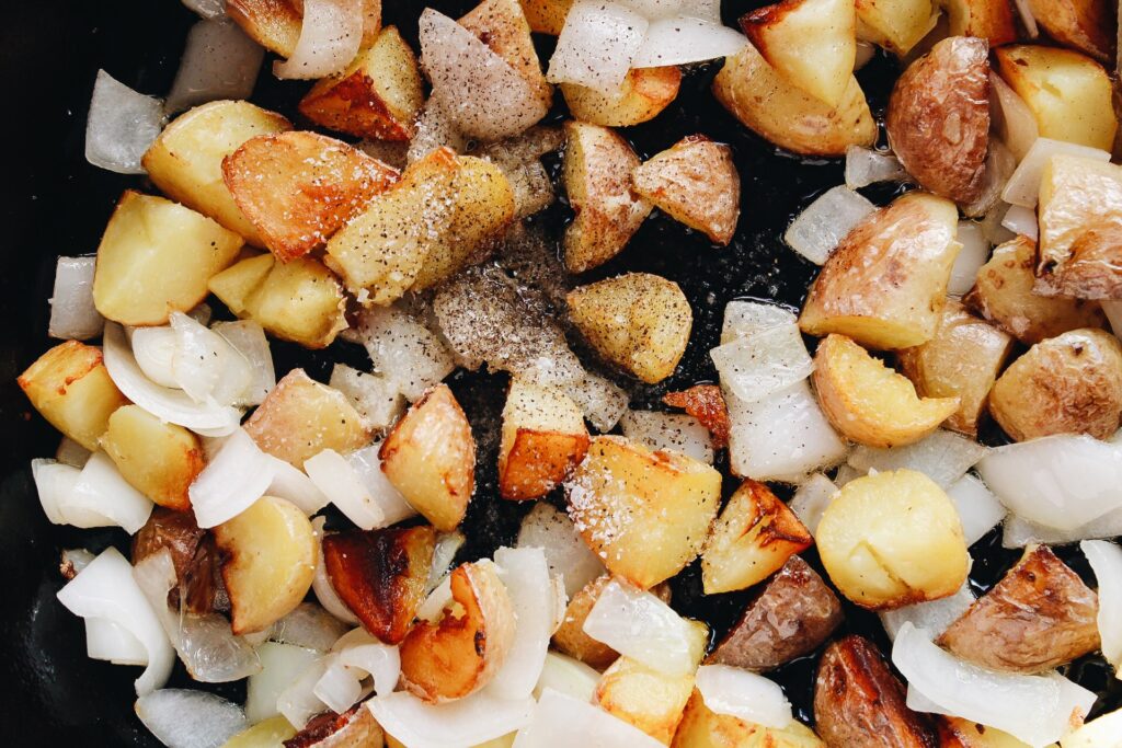 skillet fried potatoes and onions sprinkled with salt and pepper