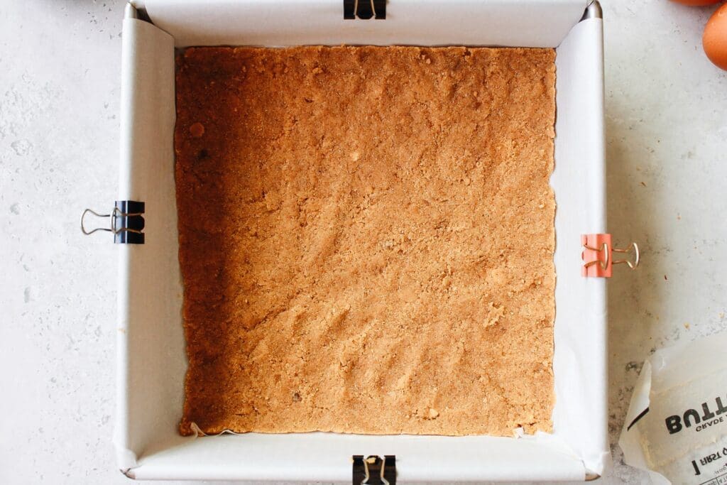 graham cracker crust in bottom of pan before baking