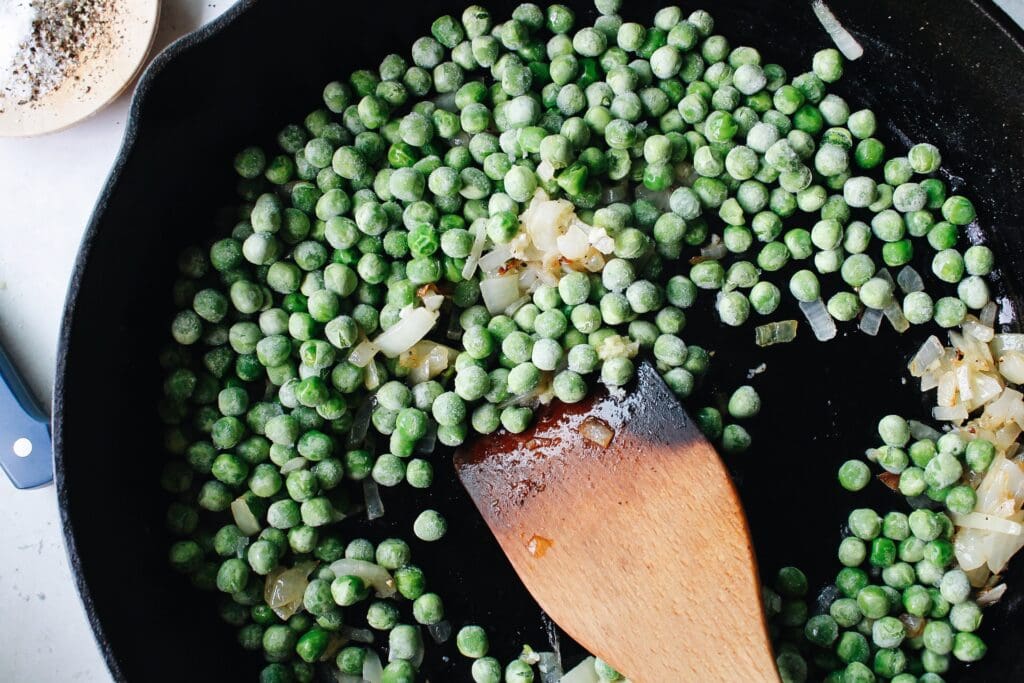 frozen peas just tossed into a cast-iron skillet with onions