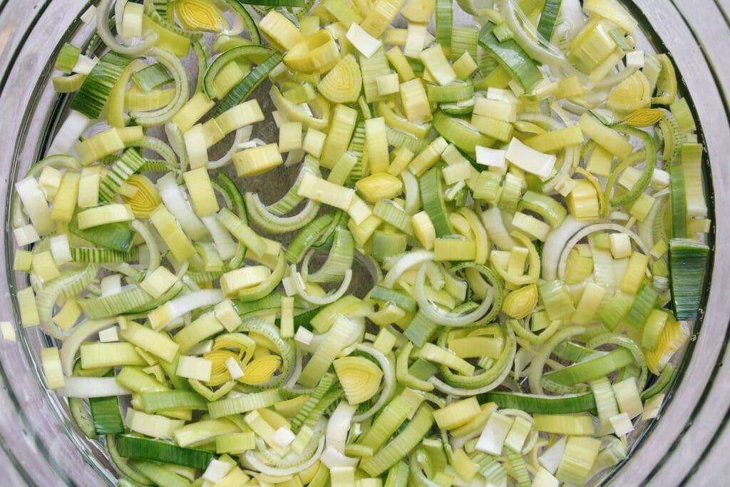 sliced leeks in a large bowl of water 