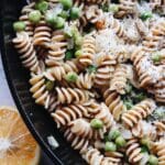 pasta with peas in a cast-iron skillet with parmesan and lemon