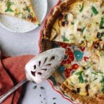 potato and leek quiche with a slice removed and on a plate