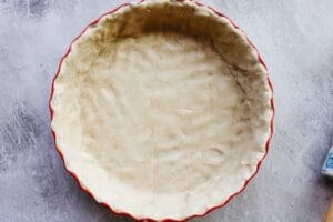 quiche crust that has been pressed into a pie dish and is ready for baking