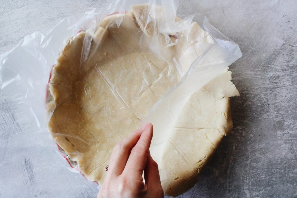 thawed pie crust in a pie/quiche baking dish
