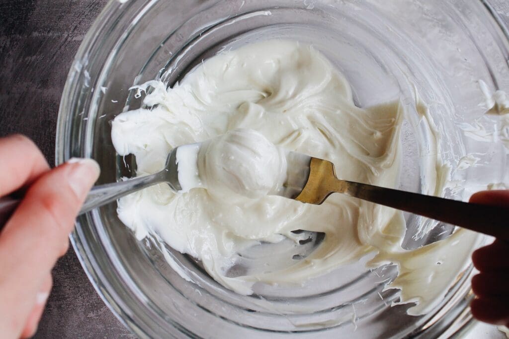 white chocolate truffle ball being coated in melted white chocolate