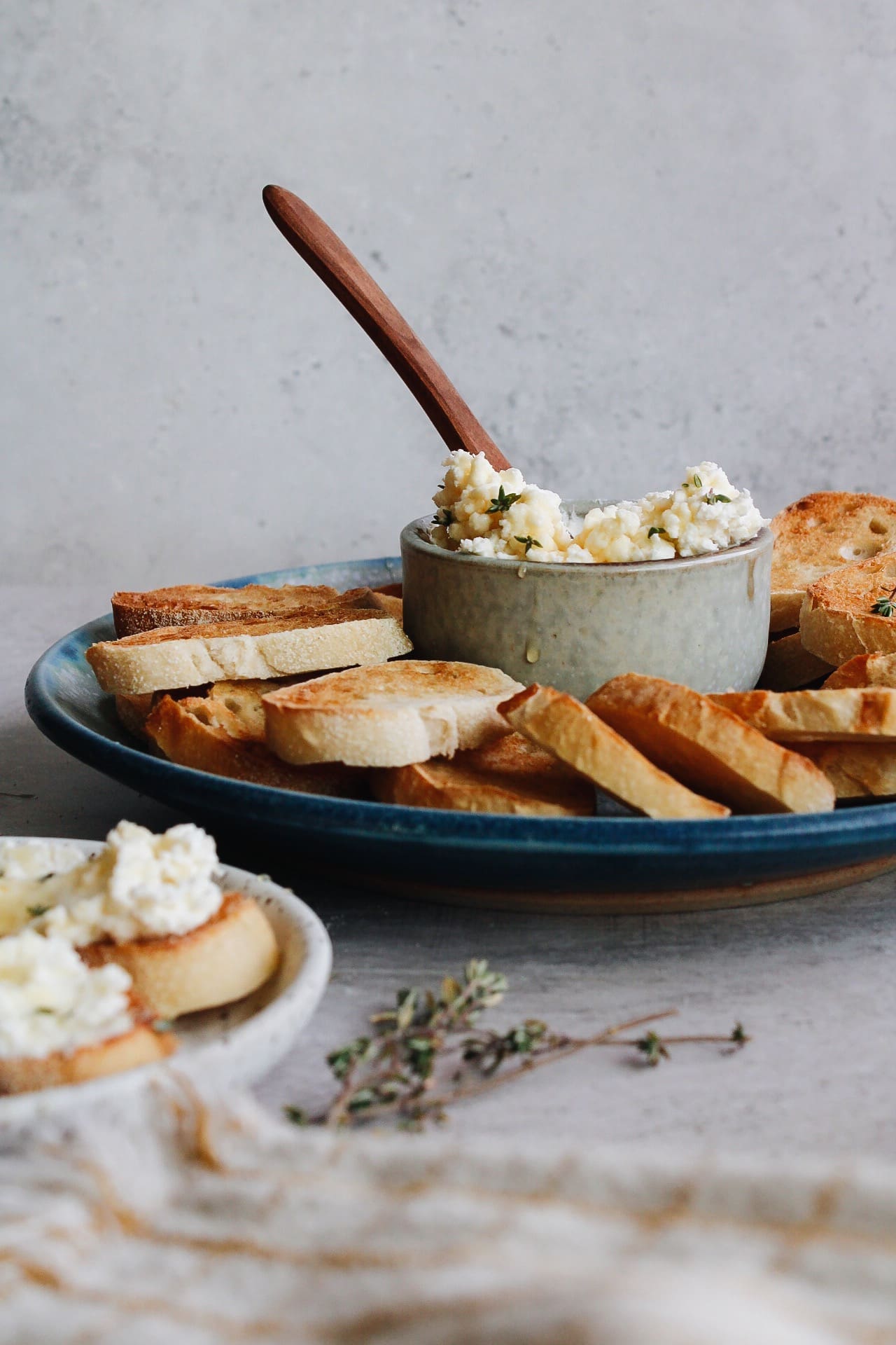 whipped feta and honey in a serving bowl surrounded by crostini