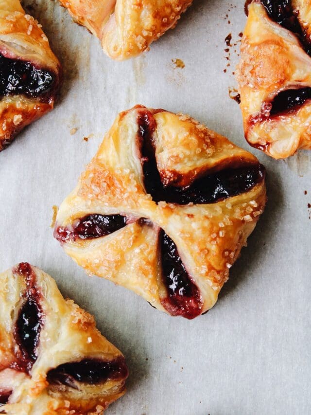 jam puff pastry tarts on parchment paper