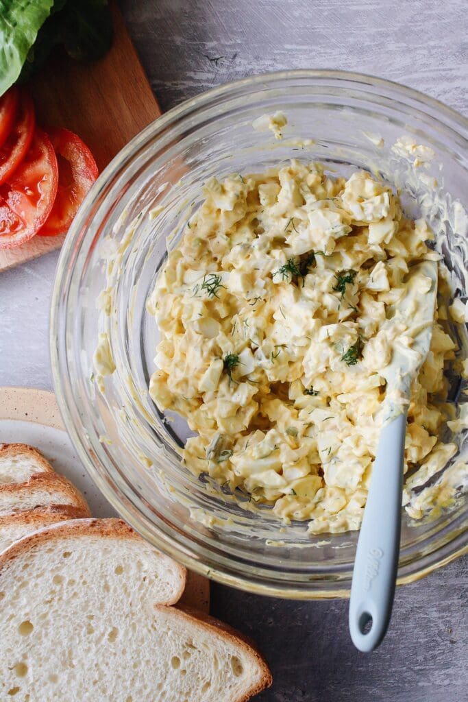 egg salad with pickles in a mixing bowl