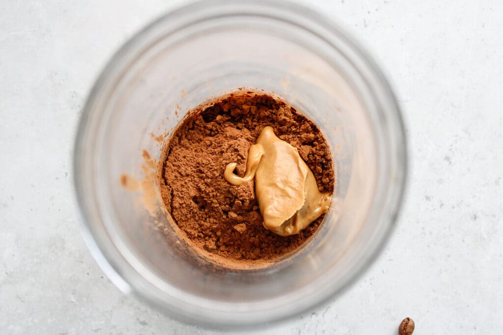 cocoa powder, sugar, vanilla, peanut butter in the bottom of a glass