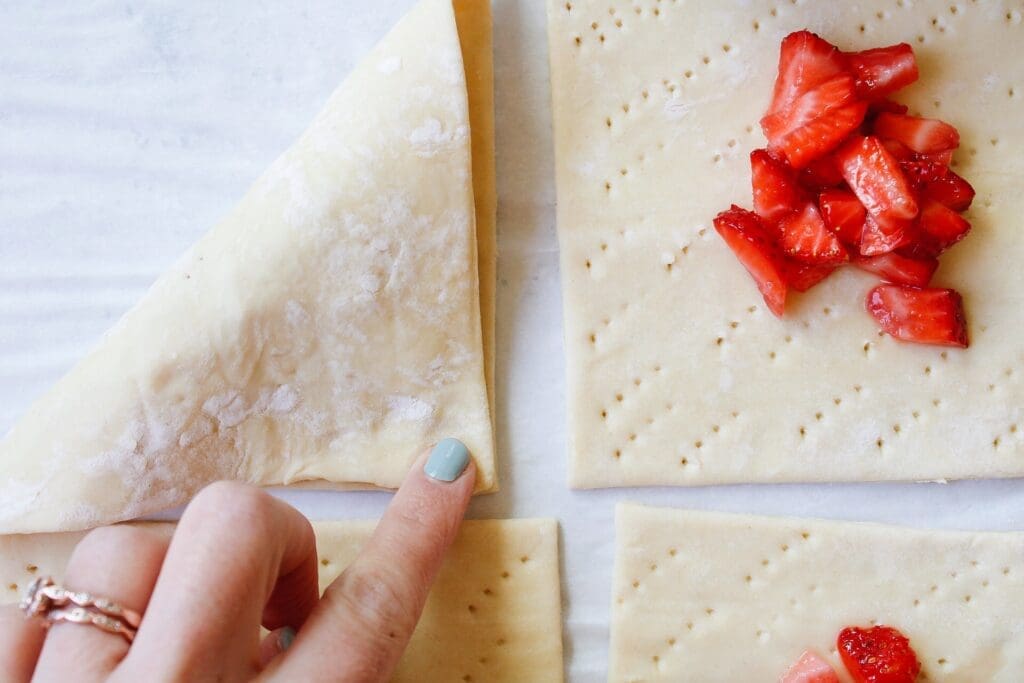 folding over an edge of puff pastry turnover