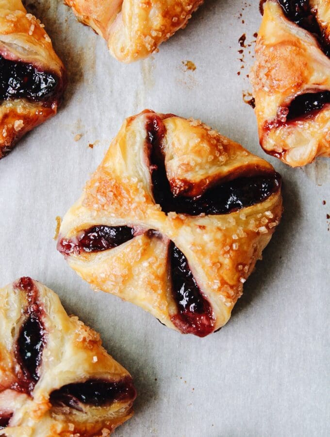 jam puff pastry tarts on parchment paper
