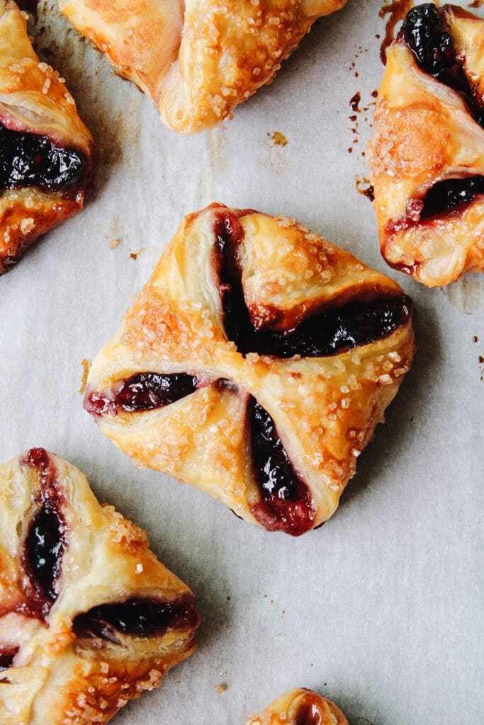 jam puff pastry tarts on parchment paper