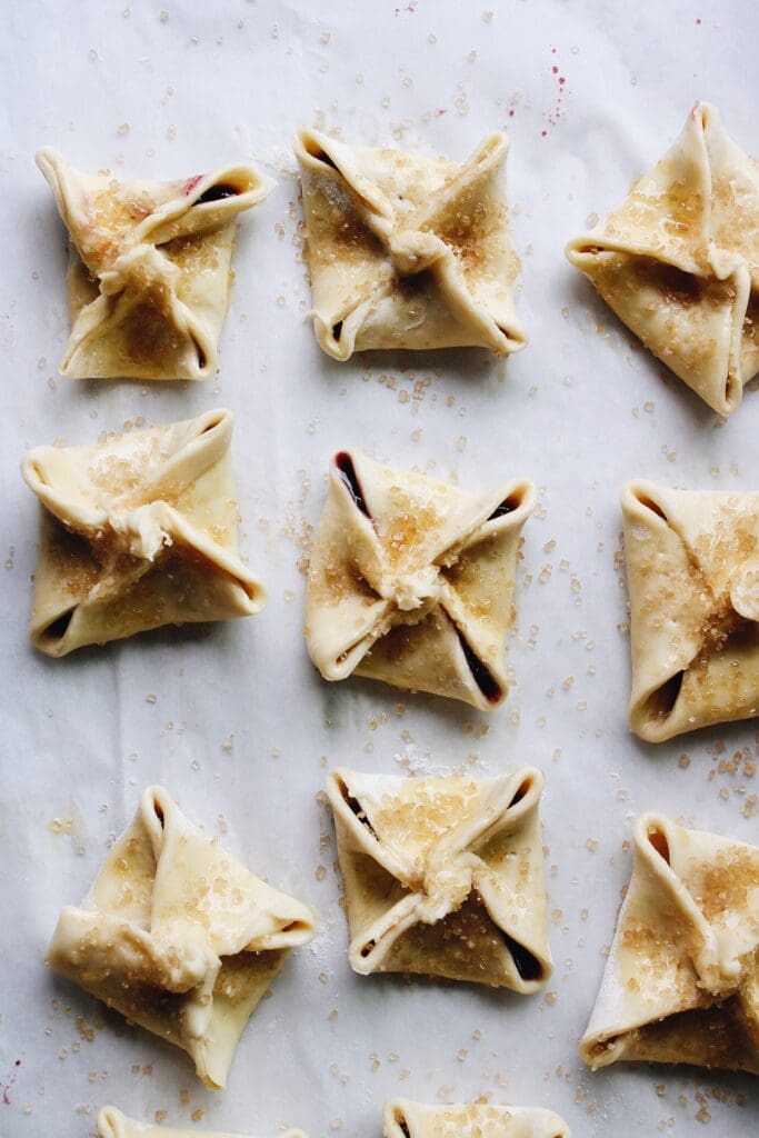 prepped puff pastry tarts with egg wash and turbinado sugar