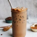 peanut butter mocha in a glass jar with peanut butter along the rim