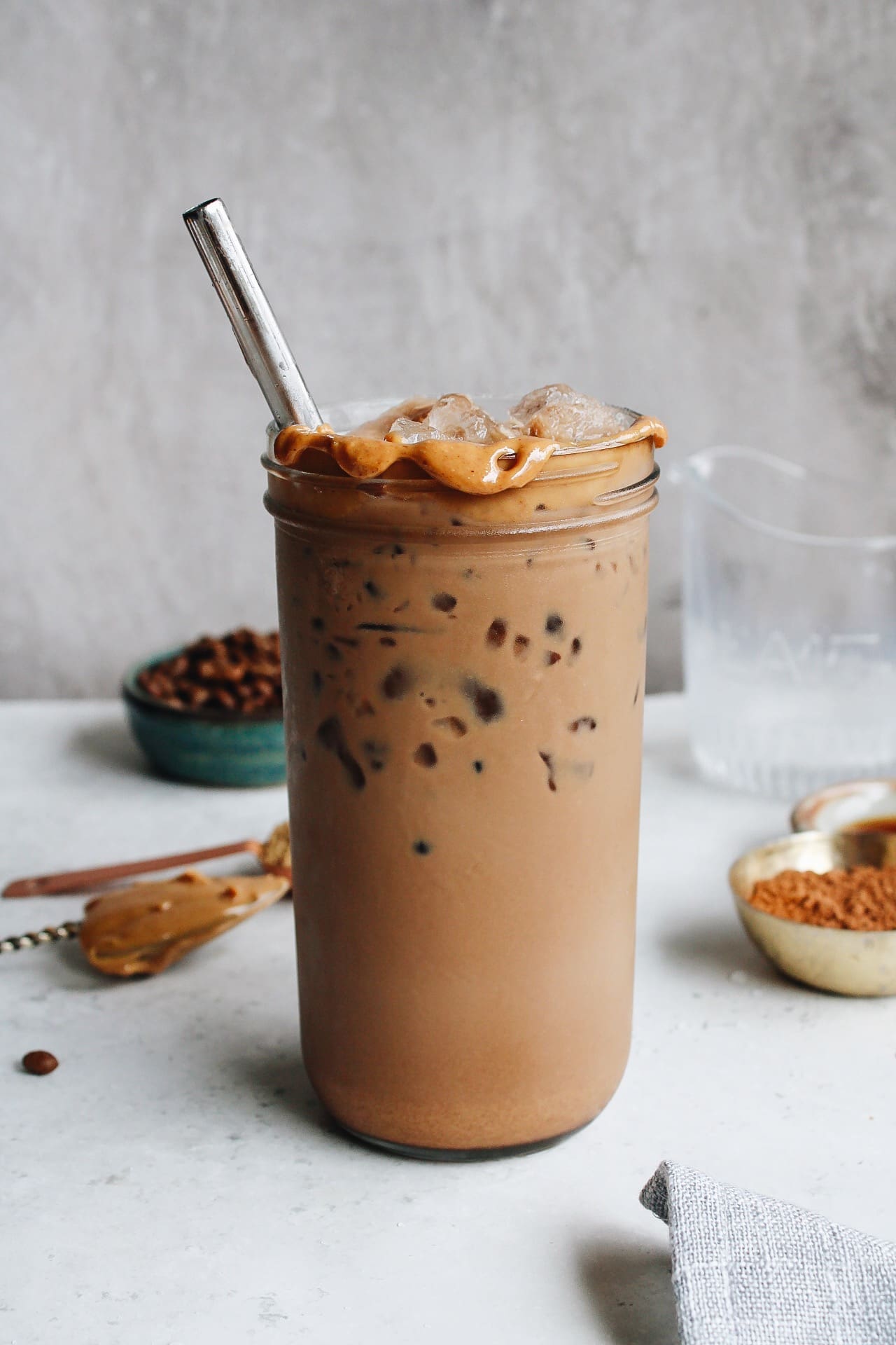 peanut butter mocha in a glass with peanut butter around the rim