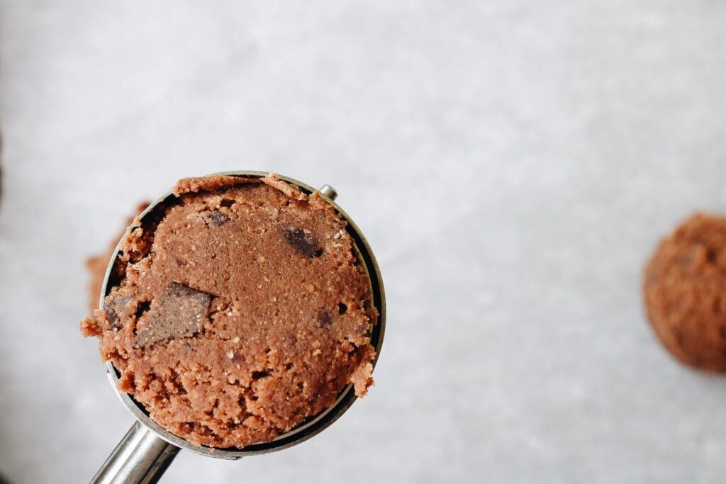 scoop of whole wheat chocolate chocolate chip cookie dough in a cookie scoop