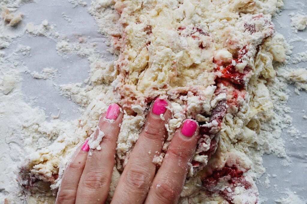 hand kneading strawberry buttermilk scone dough