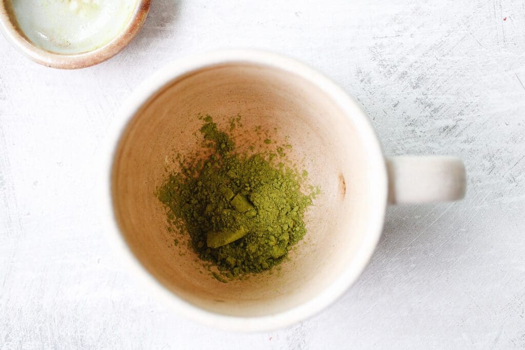 matcha powder in the bottom of a mug