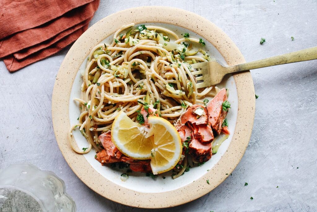 salmon pasta without cream served on a plate with lemon
