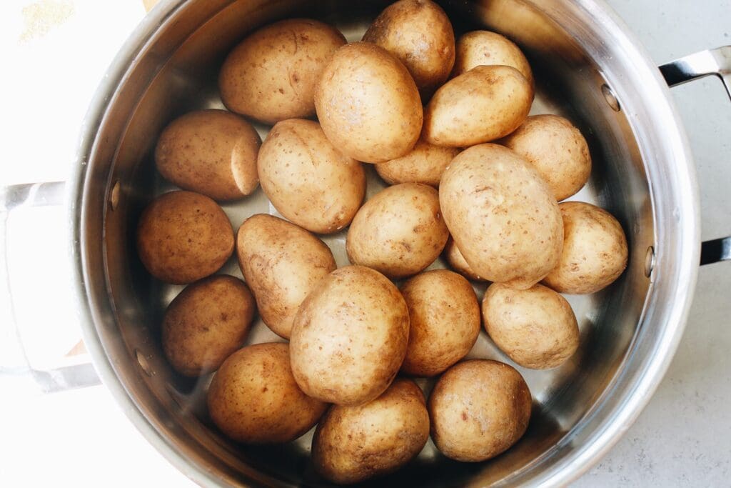 yellow potatoes in a pot covered with water