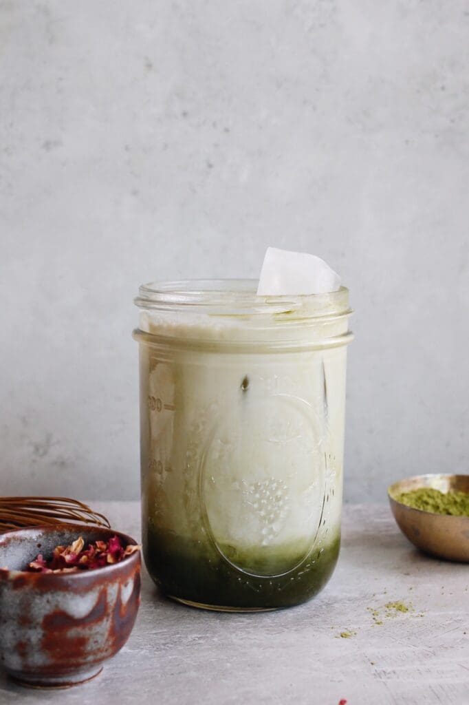 whole milk added to rose matcha mix over ice