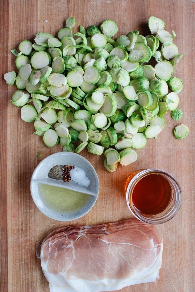 ingredients for roasted brussel sprouts on a wooden cutting board