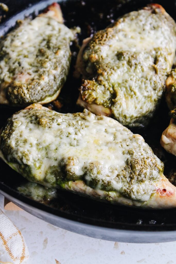 side view of pesto chicken in a skillet