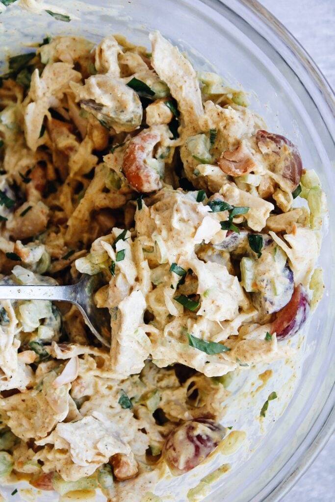 curry chicken salad with grapes in a mixing bowl
