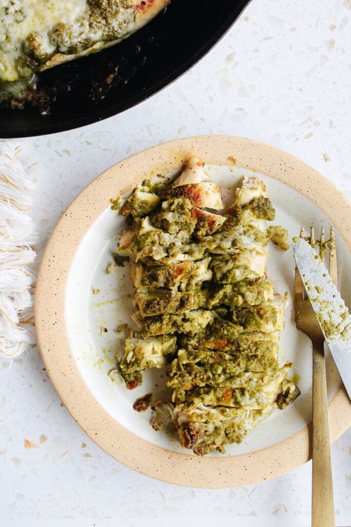 pesto baked chicken sliced on a plate