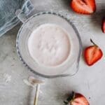 strawberry cold foam in a small glass measuring cup
