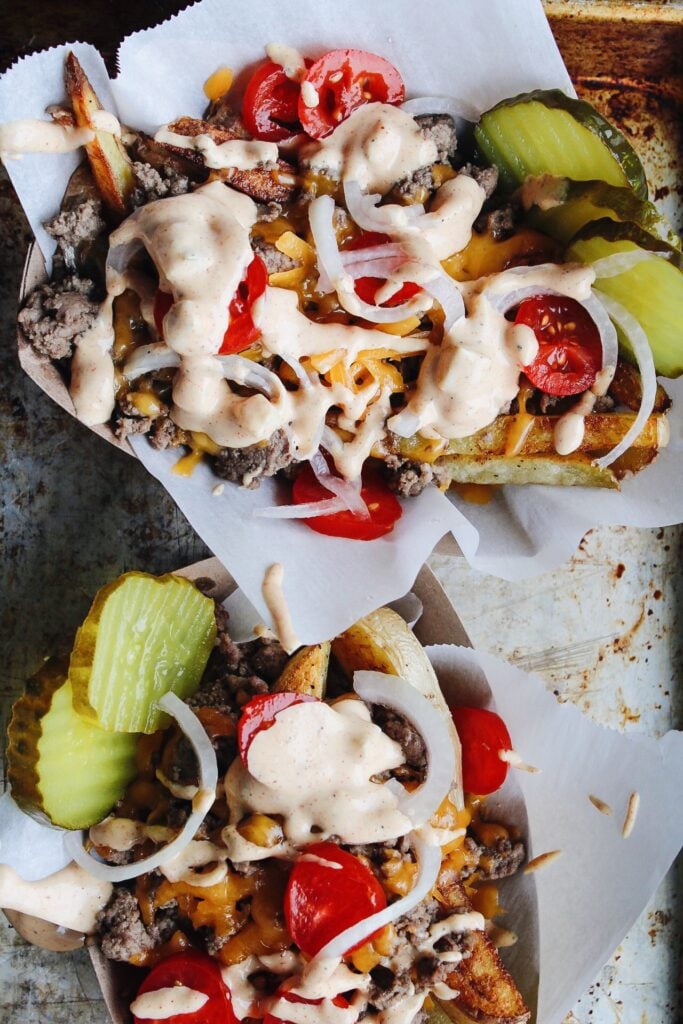 cheeseburger fries in baskets on a baking sheet
