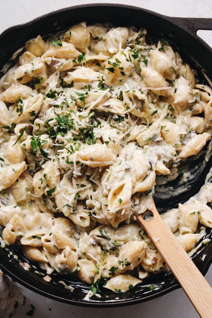 zucchini mushroom pasta with cream sauce in a skillet
