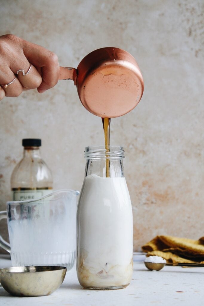 maple syrup being poured into bottle
