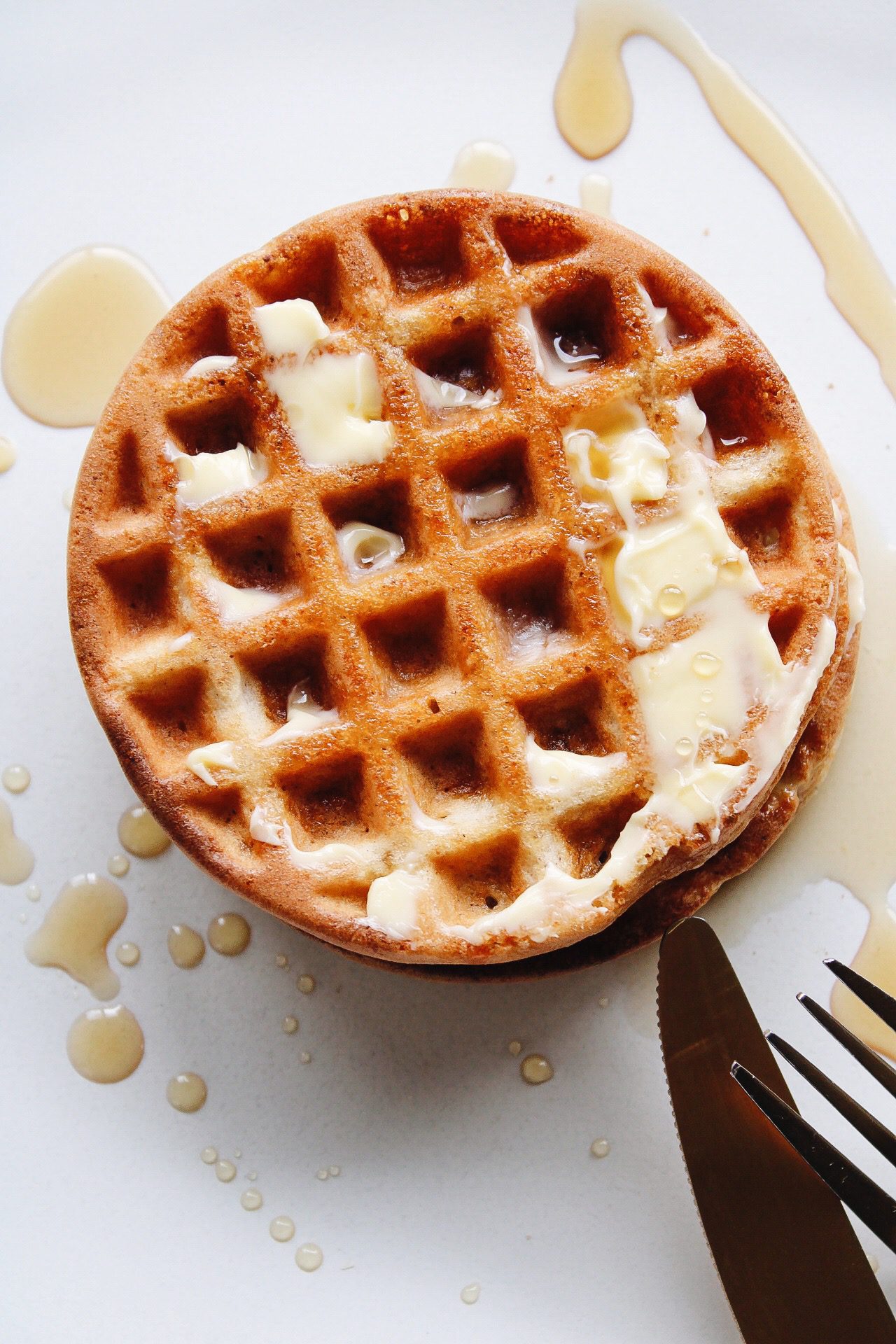 oat flour waffles on a plate with butter and syrup