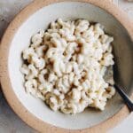 boursin mac and cheese in a bowl with a spoon
