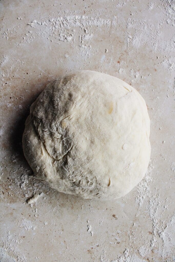 dough ball on a floured work surface