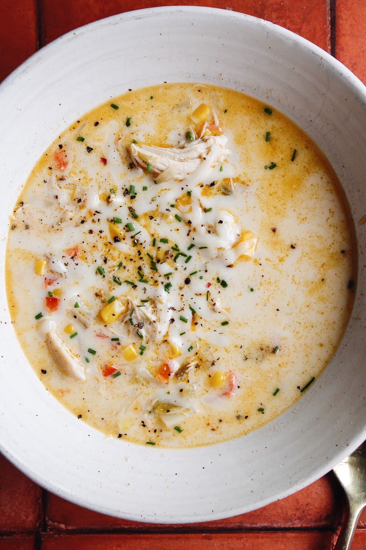 close up of chicken corn chowder in a white bowl